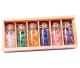 6 glass bottles filled with gemstone chips packed in a wooden box.