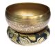 Singing bowl with flower of life engraving and cushion.